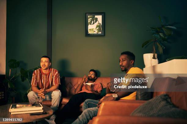 waiting on their team to do them proud - man waiting couch stock pictures, royalty-free photos & images