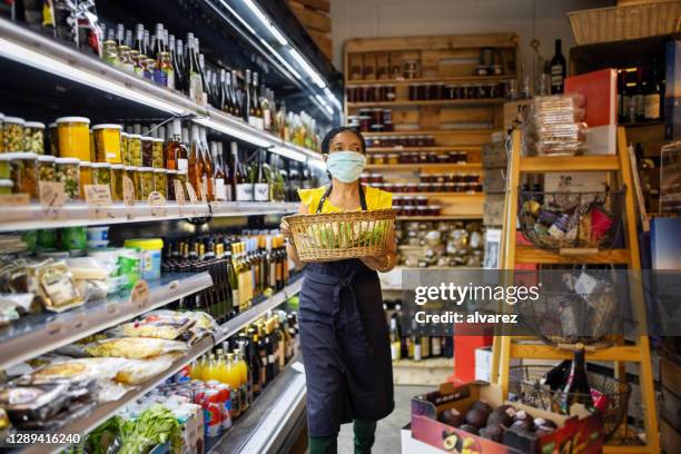 saleswoman working in deli during covid-19 crisis - essential services employees stock pictures, royalty-free photos & images