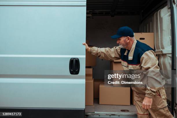 courier packing packages into his van - moving service imagens e fotografias de stock