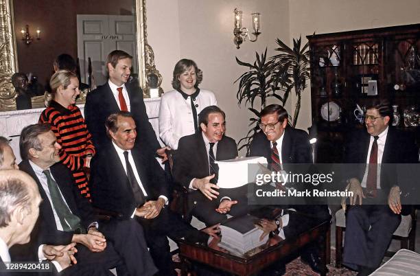 Senate Minority Leader Bob Dole along with various other senators and White House staffers including Chief of Staff John Sununu with a copy of the...