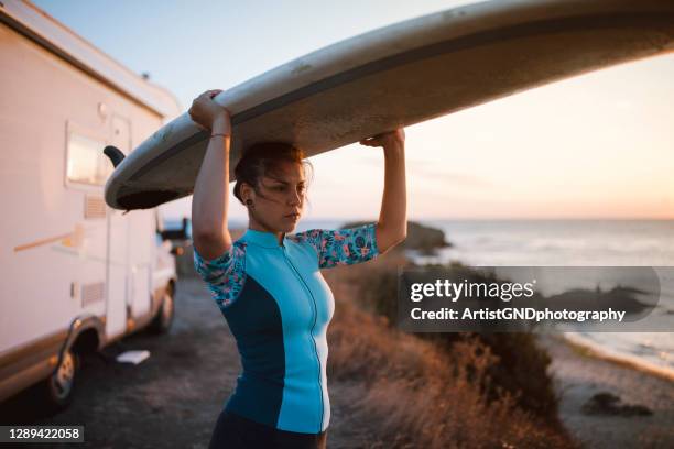 verticale du surfer féminin sur la plage. - concentration camp photos photos et images de collection