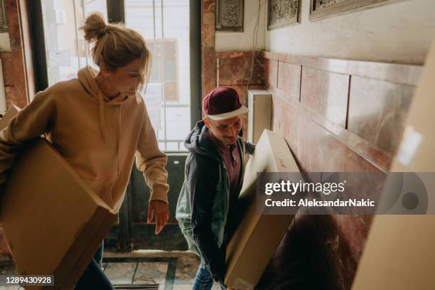 young couple moving into a new building - carrying wife stock pictures, royalty-free photos & images