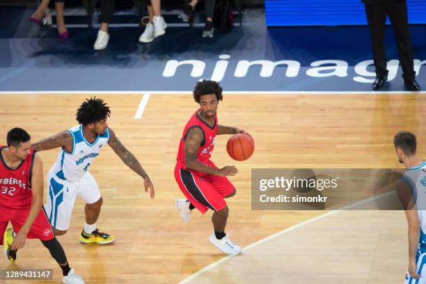 basketball player dribbling ball - basketball-dribbling stock pictures, royalty-free photos & images