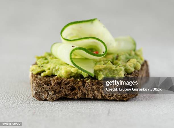 avocado cucumber sandwich with whole grain bread - avocado toast stockfoto's en -beelden