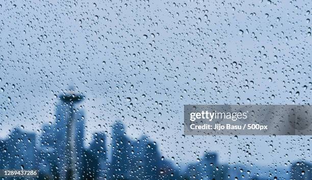 full frame shot of wet glass window,seattle,wa,united states,usa - seattle rain stock pictures, royalty-free photos & images