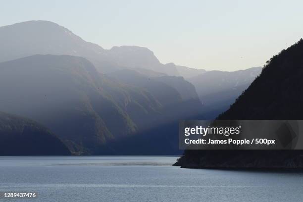scenic view of sea and mountains against clear sky,fv,norway - james popple stock pictures, royalty-free photos & images