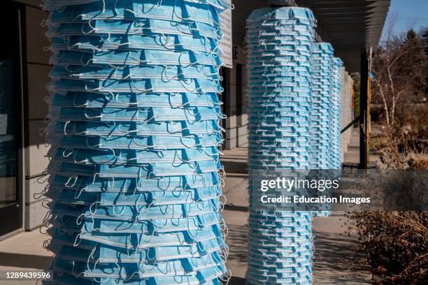 White Bear Lake, Minnesota. Face masks put up by artist Seing Lee line the columns In memory of Minnesotans who lost their lives due to Covid 19....