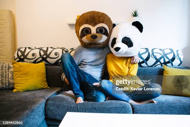 man and a woman hugging on the sofa - unexpected stock pictures, royalty-free photos & images