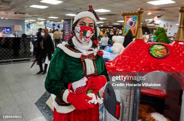 Santa Claus's elf wears her mandatory protective mask in Corte Ingles department store during the COVID-19 Coronavirus pandemic on December 04, 2020...