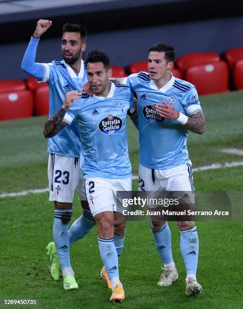 Hugo Mallo of Celta de Vigo celebrates his team's first goal with teammates Brais Mendez and Santi Mina during the La Liga Santander match between...