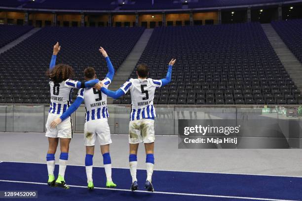Matteo Guendouzi, Krzysztof Piatek and Niklas Stark of Hertha celebrate with imaginary fans in front of the empty stand after winning the Bundesliga...