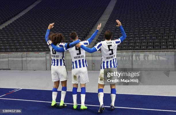 Matteo Guendouzi, Krzysztof Piatek and Niklas Stark of Hertha celebrate with imaginary fans in front of the empty stand after winning the Bundesliga...