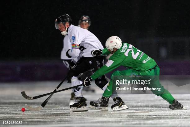 Daniel Berlin of Sandvikens AIK battles for possession with Fredrik Larsson of Hammarby IF during the Elitserien bandy match between Hammarby IF and...