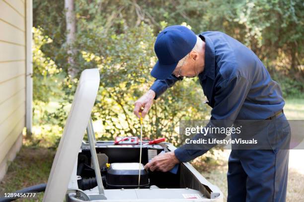 technician services outside ac units and generator. - gerador imagens e fotografias de stock