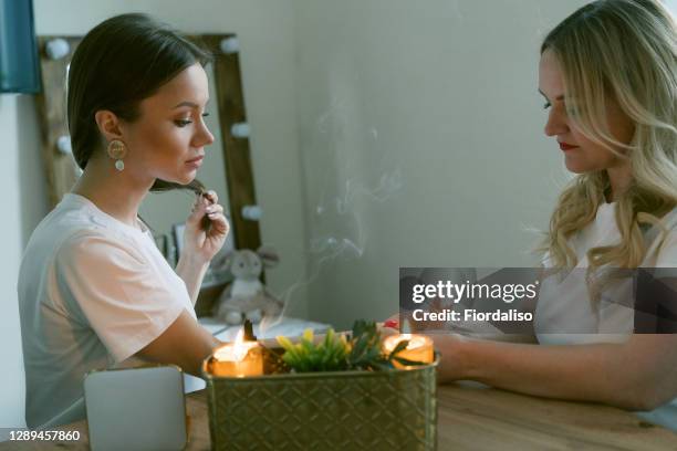 young beautiful girl and a middle-aged woman - waarzeggerij stockfoto's en -beelden