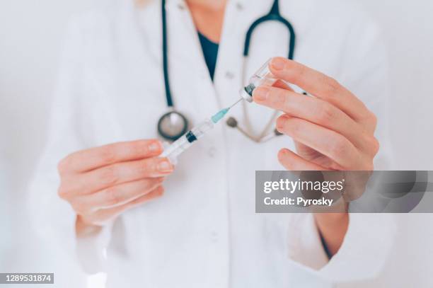 the doctor prepares a vaccine for vaccination. - steroids stock pictures, royalty-free photos & images