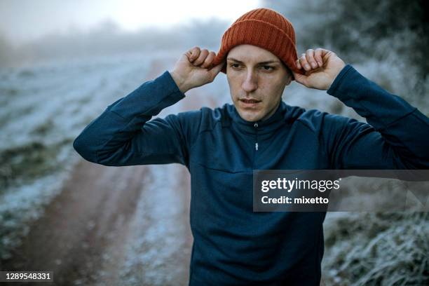 getting prepared for running - only young men stock pictures, royalty-free photos & images