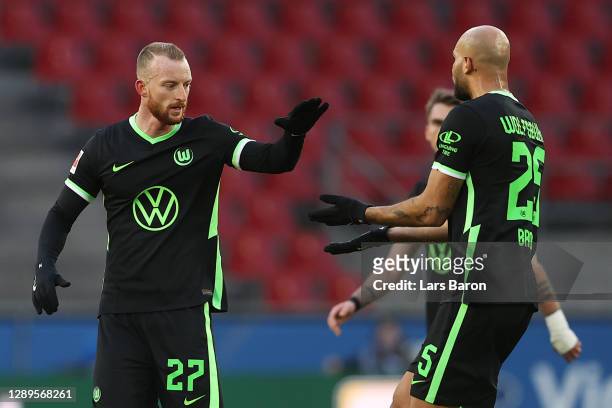 Maximilian Arnold of VfL Wolfsburg celebrates with teammate John Brooks after scoring his team's first goal during the Bundesliga match between 1. FC...