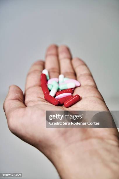 hand full of big pile of different pills - immune system stock pictures, royalty-free photos & images