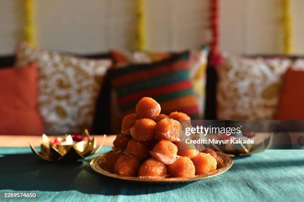 arrangement of lamps and laddoos during diwali celebration - indian food on table stock pictures, royalty-free photos & images