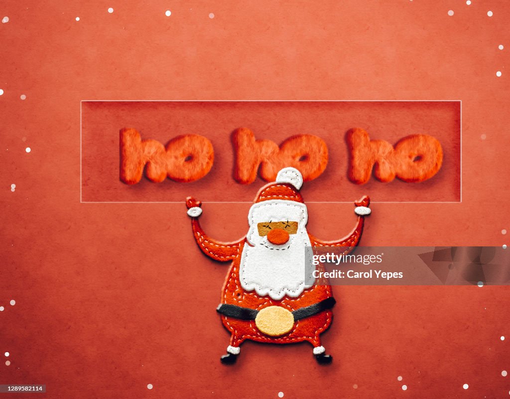 Santa claus with ho ho ho text made of felt in red