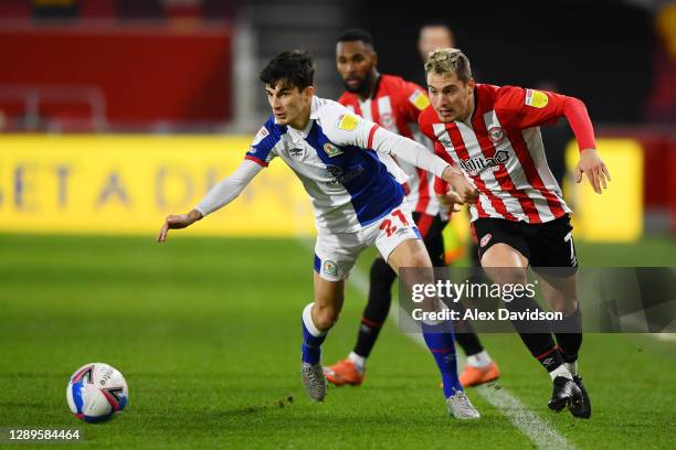 Sergi Canos of Brentford battles for possession with John Buckley of Blackburn Rovers during the Sky Bet Championship match between Brentford and...