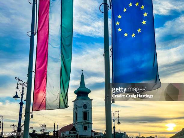 european union and hungarian flag amid a business corperate setting - hungary stock pictures, royalty-free photos & images
