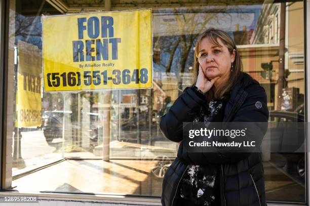 Lori Zegel, stands in front of the now empty, storefront which used to be her clothing boutique called Nook and Cranny in Islip, New York, on...