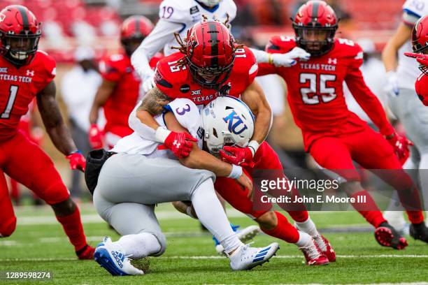 Linebacker Thomas Leggett of the Texas Tech Red Raiders tackles quarterback Miles Kendrick of the Kansas Jayhawks during the first half of the...