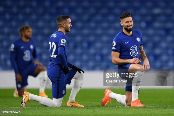 Hakim Ziyech and Olivier Giroud of Chelsea takes a knee in support of the Black Lives Matter movement during the Premier League match between Chelsea...