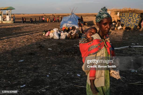 Refugees from the Tigray region of Ethiopia wait to be transferred to a camp with more infrastructure at a UNHCR reception area in the east Sudanese...