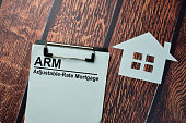 ARM - Adjustable-Rate Mortgage write on a paperwork isolated on office desk.
