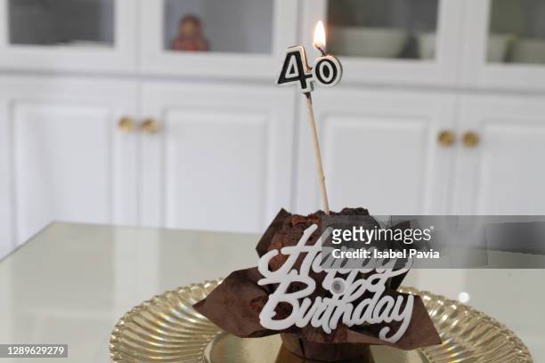 close-up of birthday cake with candle - 40 birthday stock pictures, royalty-free photos & images