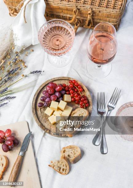 french summer picnic with rose wine and cheese - wine basket stock pictures, royalty-free photos & images