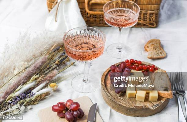 french summer picnic with rose wine and cheese - wine basket stock pictures, royalty-free photos & images