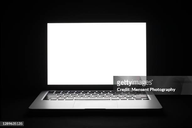 close-up illuminated laptop with white screen isolated in black background - laptop close up stock pictures, royalty-free photos & images