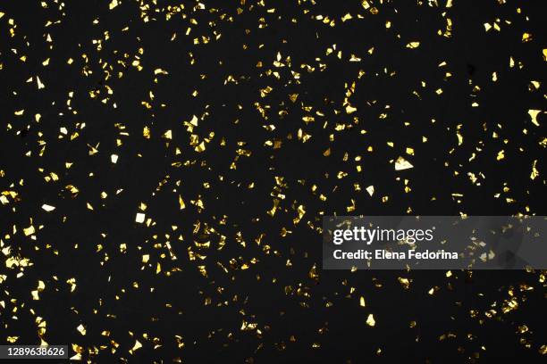 festive black background with gold sparkles - confetti gold ストックフォトと画像