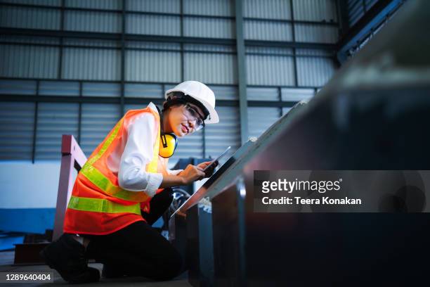 female engineer inspecting the workpiece in a steel factory. - engineer stock pictures, royalty-free photos & images
