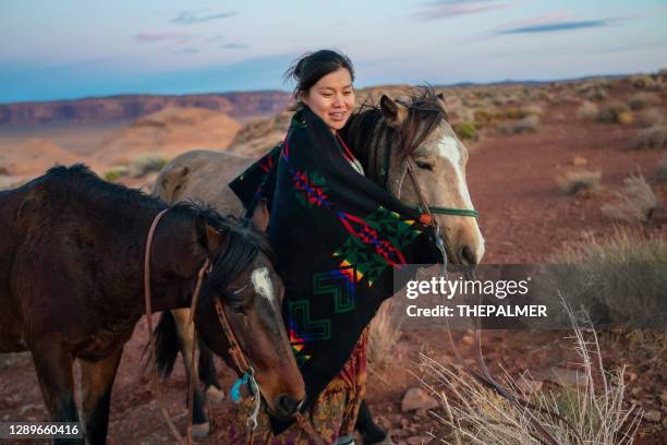 native american woman hugging her beloved horse at the arizona desert - horse blanket stock pictures, royalty-free photos & images