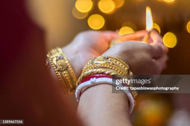 indian woman holding diwali lamp - bracelet festival stock pictures, royalty-free photos & images