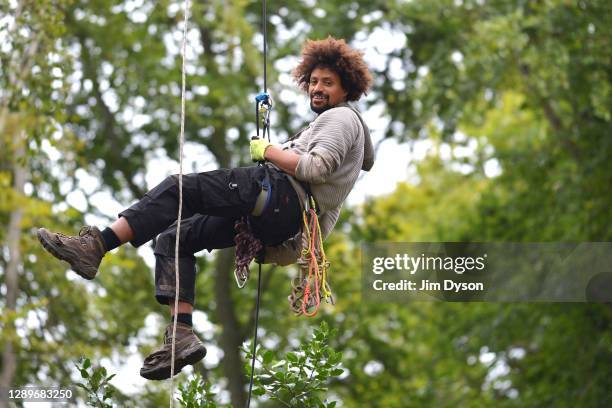 Environmental activist, Will, climbs to his tree house in Jones Hill Wood at a protest camp against the HS2 High Speed Rail line and its proposed...