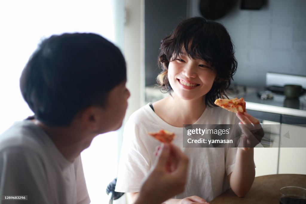 Couple eating pizza