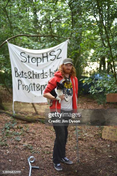 Environmental activist, Ross, poses for a portrait with Cooper in Jones Hill Wood at a protest camp against the HS2 High Speed Rail line and its...