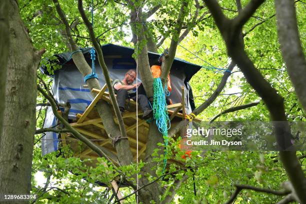 Environmental activist, Steve Masters, works from his tree house in Jones Hill Wood at a protest camp against the HS2 High Speed Rail line and its...