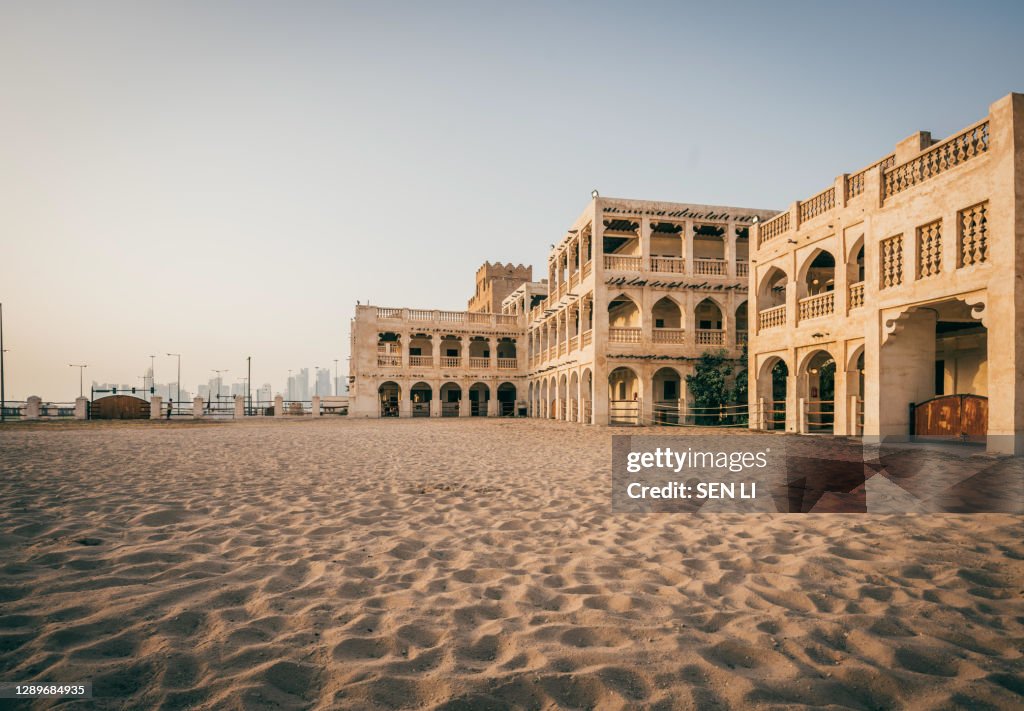 Doha city street with traditional Islamic architecture buildings