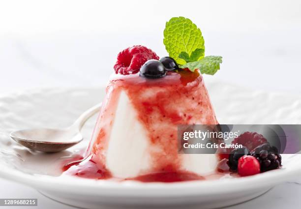 panna cotta with berries - coulis stock pictures, royalty-free photos & images