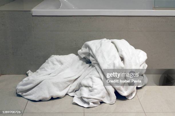 dirty towels on bathroom floor - white laundry foto e immagini stock