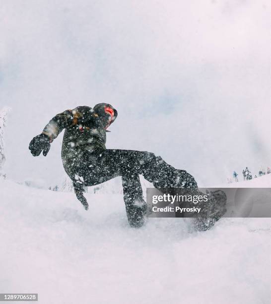 snowboarder rides fast at ski slope - man snow wind stock pictures, royalty-free photos & images