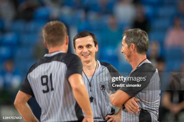 referees standing in court - referee stripes stock pictures, royalty-free photos & images