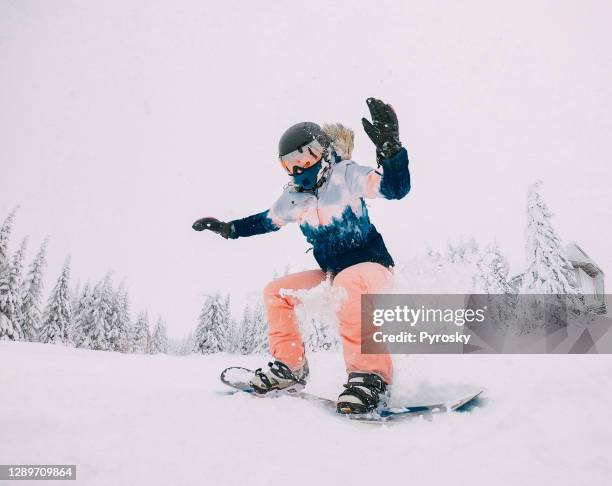 snowboarder jumps with snow dust - youth culture speed stock pictures, royalty-free photos & images